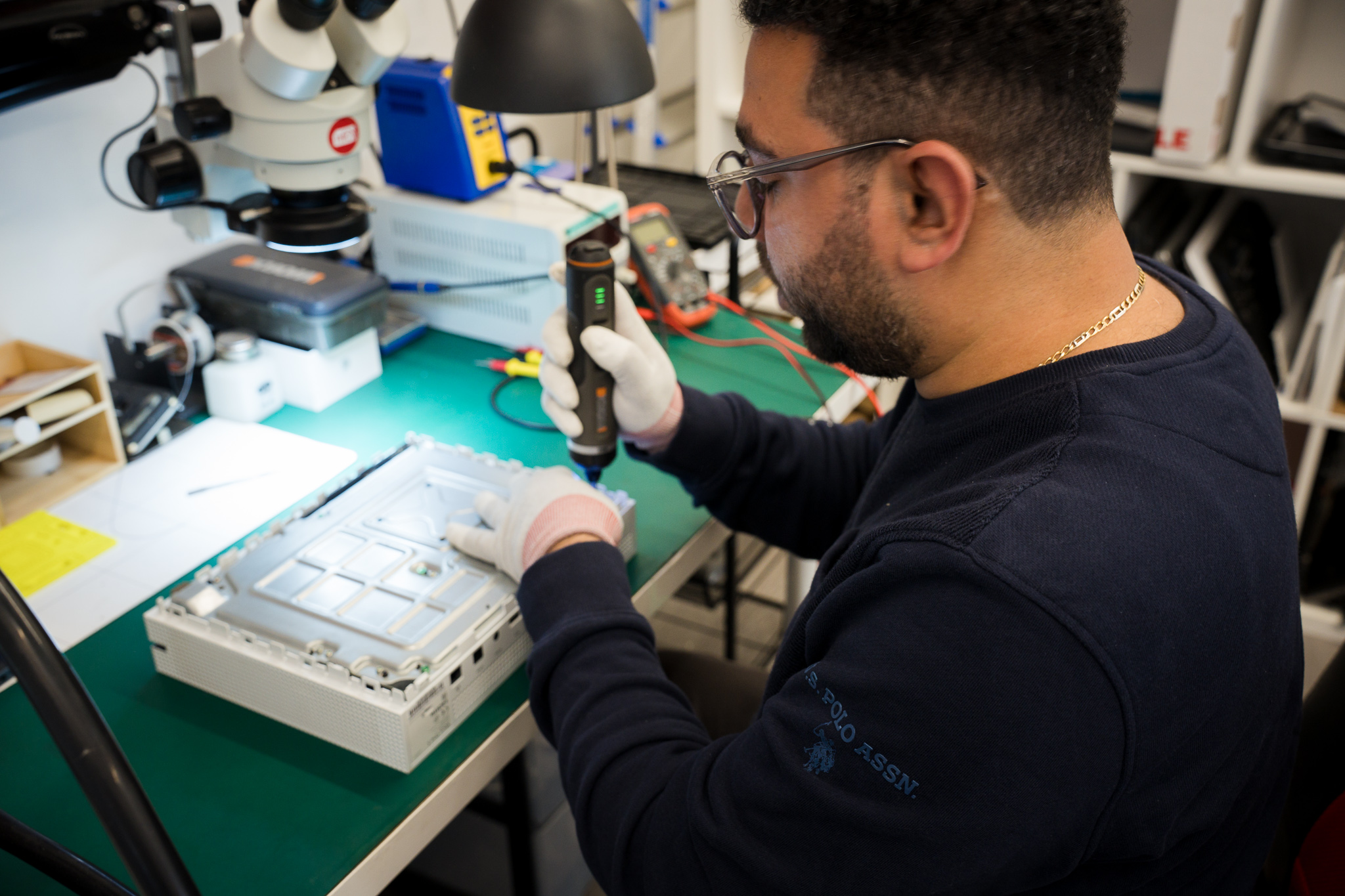 Technician repairing game console motherboard at Tech Lab Worthing